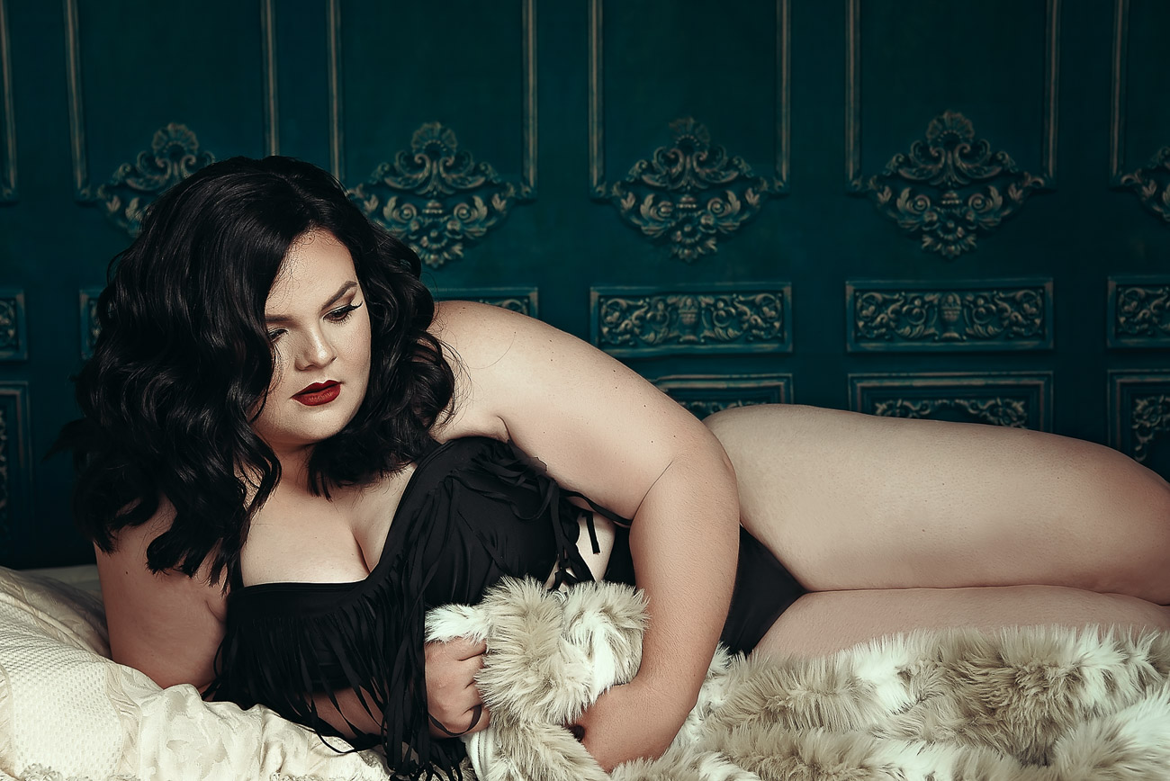 Beautiful "Plus" Size Woman posing with fur in her dream boudoir session